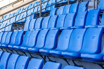 empty seats blue plastic in a stadium.
