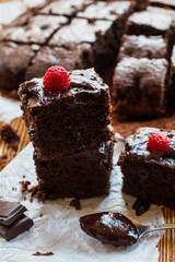 Homemade chocolate brownies with raspberry on the wooden background