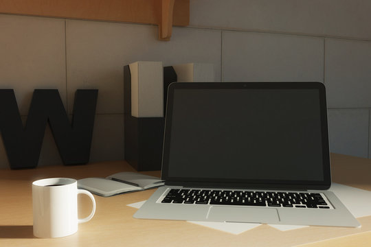 Blank laptop on creative desktop