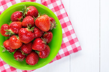 Strawberries on checkered napkin.