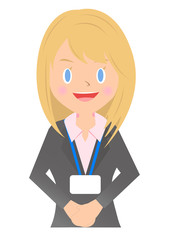 ネームホルダーをつけた女性会社員　立ち姿