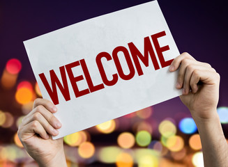 Welcome placard with night lights on background