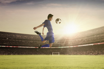 Fototapeta na wymiar Football player withstand a ball