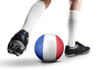 Legs fo football player playing a ball