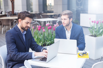 Successful business partners are working in cafe
