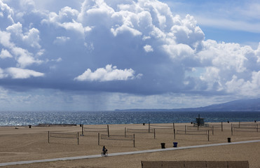 Picturesque thick clouds, beach landscape. Clouds over the beach in Santa Monica, United States. The ocean during strong winds.