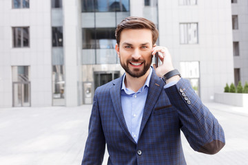 Successful businessman is talking on mobile phone