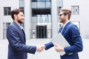 Happy two business partners greeting each other