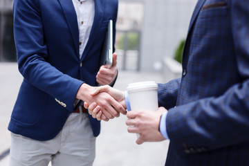 Cheerful business partners are shaking hands