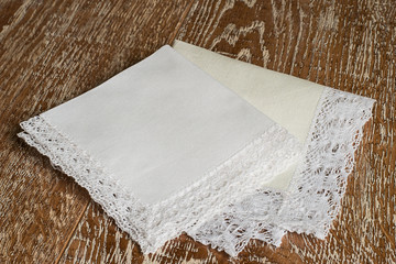  Handkerchiefs with a decorative trim.   White handkerchiefs with a decorative trim on a brown...