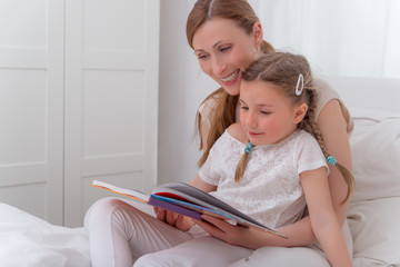 mother reading to daughter