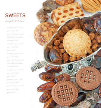 Eastern sweet (still life with nuts, candy, vase and date isolated on white background)