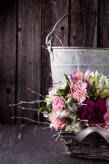 Fototapeta na wymiar Pink bouquet from gillyflowers and alstroemeria in the basket on