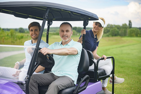 Attractive family in their golf cart