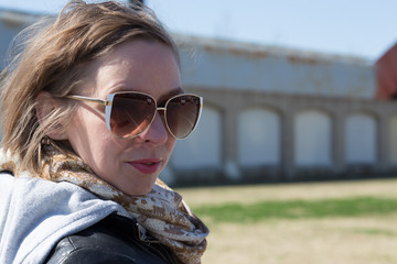 Woman in sunglasses with messy windswept short blonde hair