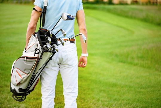 Golfer Walking With Golf Bags