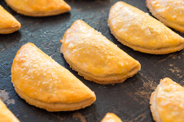 Freshly baked cookies with curd on a pan