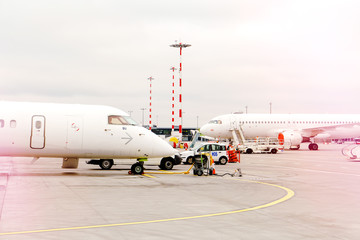 Fototapeta premium two side profile parked airplanes with windows of wide-body airplane.