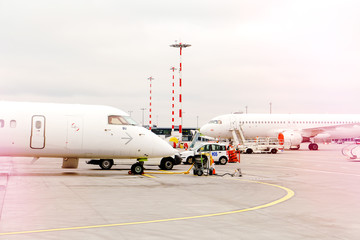 two side profile parked airplanes with windows of wide-body airplane.