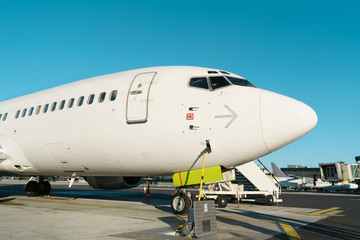 Front profile and cockpit windows of wide-body airplane.