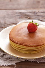 stack of delicious pancake with strawberry topping
