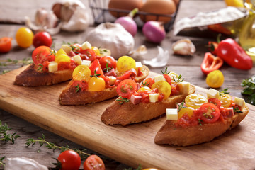 italian homemade bruschetta on wooden cutting board