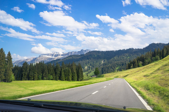 Driving through the scenic Emmental valley in Switzerland. View from the front seat while moving.
