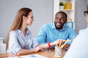 Positive colleagues sitting at the table