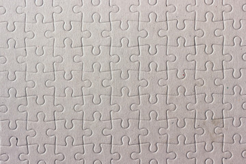 A sheet of cardboard cut into puzzles. Texture.