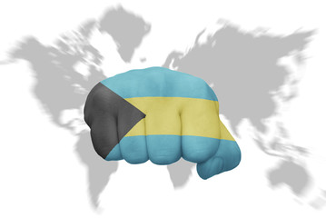 fist with the national flag of bahamas on a world map background