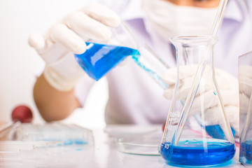 Scientists are experimenting with chemicals. A scientific beaker vitro camera microscope can be used in scientific articles or books about chemistry, scientists are Asian women .