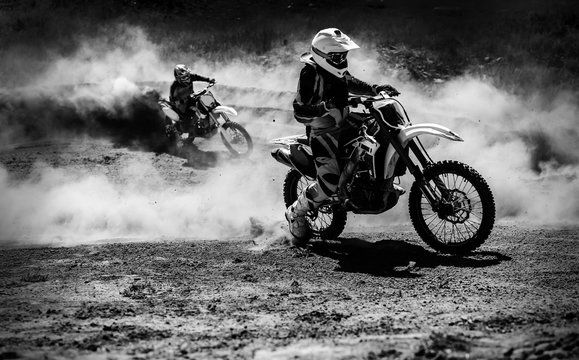 Motocross racer accelerating in dust track, Black and white photo © Maksim Kostenko