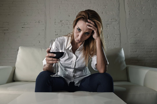 sad depressed alcoholic drunk woman drinking at home in housewife alcohol abuse and alcoholism