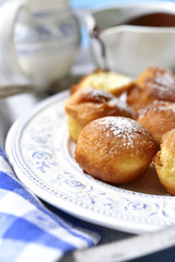 Vanilla doughnuts with chocolate sauce.
