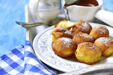 Vanilla doughnuts with chocolate sauce.