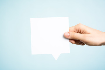 Blank speech bubble on blue background. White copy space.