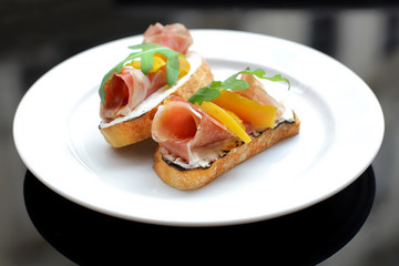 sandwich with salmon, greens and tomato
