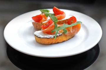 sandwich with salmon, greens and tomato
