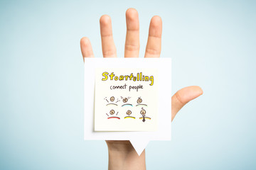 Fototapeta na wymiar Storytelling art for kids concept. Hand up showing a paper note illustrated.