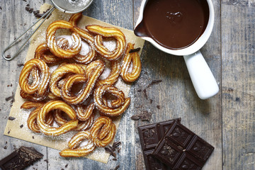 Traditional mexican dessert churros with chocolate sause.