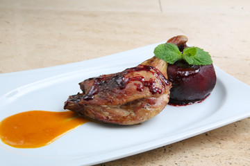 Roasted duck leg baked with apple in red wine

