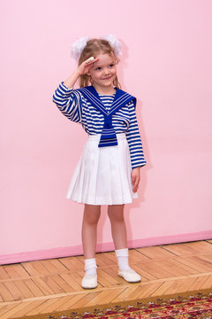little girl in sailor suit salutes