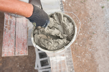 worker aligns with a spatula, lay brick cinderblocks