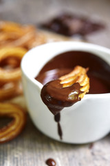 Traditional mexican dessert churros with chocolate sause.
