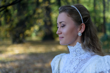 Young woman turned left in front of the trees