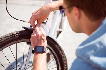 Young man repairing his bike
