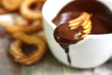 Traditional mexican dessert churros with chocolate sause.