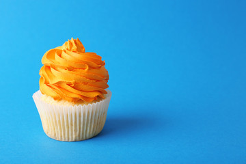 Birthday cupcake on blue background