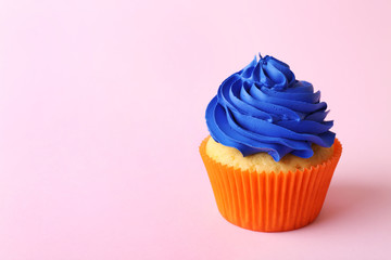 Birthday cupcake on light pink background