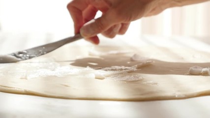 Puff pastry manually making with fat spreading over dough with knife 4K 2160p UltraHD footage - Laminated dough layer on table spread butter 4K 3840X2160 UHD video - Powered by Adobe